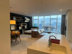 a kitchen and living room with a view of a city at Pool View Platinum KLCC in Kuala Lumpur