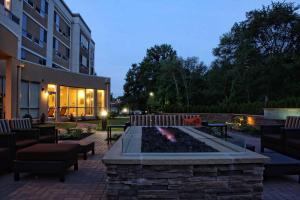 a patio with a fire pit in front of a building at Courtyard by Marriott Philadelphia Bensalem in Bensalem