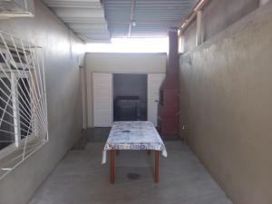 a room with a table with a table cloth on it at Casa no centro de Penha in Penha