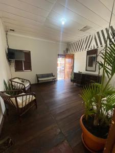 una habitación vacía con sillas y plantas. en Puente Real Hostel en Liberia