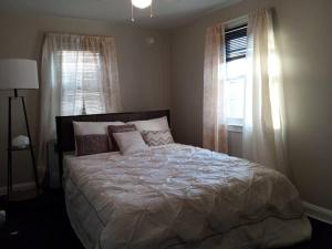 a bedroom with a large bed and a window at Eddystone - Entire Property 
