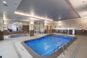 a large swimming pool in a hotel room at Fairfield by Marriott Edmonton International Airport in Edmonton