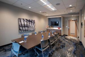 a conference room with a long table and chairs at Fairfield by Marriott Edmonton International Airport in Edmonton