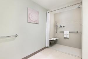 a white bathroom with a shower and a toilet at Residence Inn by Marriott San Juan Isla Verde in San Juan