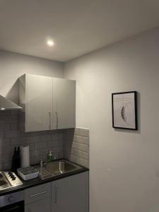 a kitchen with a sink and a counter top at King Bed Studio Apartment in Central Northampton in Northampton