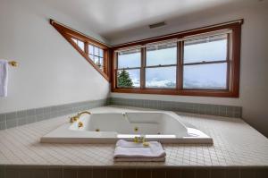 a white bath tub in a bathroom with a window at Casia Lodge and Ranch in Twisp +66 photos
