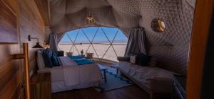 a room with two beds and a view of the beach at Salinas Grandes Jujuy - Pristine Luxury Camp 