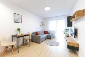 a living room with a couch and a table at Apartamenty Meiera in Kraków