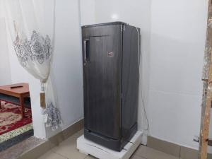 a small refrigerator in a corner of a room at Mombasa Comfort House, Old Town in Mombasa
