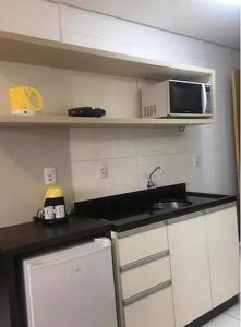 a small kitchen with a sink and a microwave at Executive 106 Sem Garagem in Caxias do Sul
