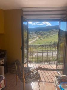 a room with a balcony with a chair and a view at ENJOY VALDELINARES in Valdelinares