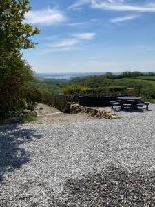 a picnic table on top of a hill with a view at 5th Wheel Trailer in Bere Alston
