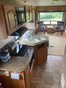 an rv kitchen with a sink and a stove at 5th Wheel Trailer in Bere Alston