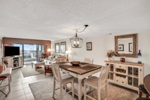 a dining room and living room with a table and chairs at B110 Amelia Surf and Racquet in Fernandina Beach