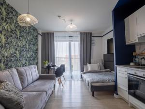 a living room with a couch and a table at Enes Apartments Softy Lofty 4 in Wrocław