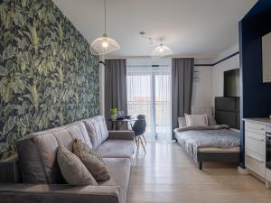 a living room with a couch and a bed at Enes Apartments Softy Lofty 4 in Wrocław