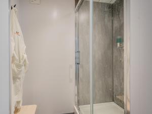 a shower with a glass door in a bathroom at Harbour View House in Girvan