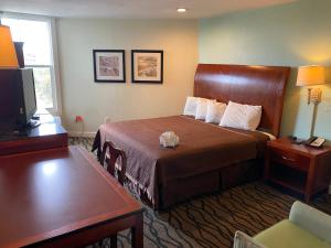 a hotel room with a bed and a television at Outer Banks Inn in Kill Devil Hills