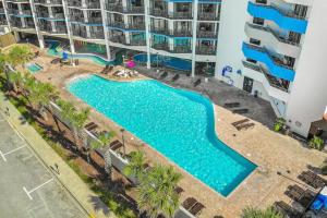 uma vista superior de uma piscina em frente a um edifício em Ocean Reef- Unique Oceanfront Condo-Free parking - Amazing pools em Myrtle Beach