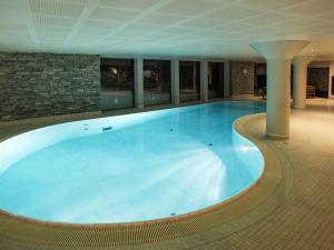 a large swimming pool in a large building at Apartment Havsdalshovda - HLD101 by Interhome in Geilo