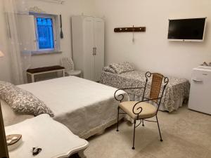 a bedroom with a bed and a chair and a couch at Il Casale Di Kevin in Monopoli