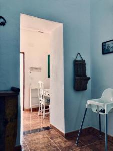 a room with a table and chairs and a white wall at Casita Volcan Lanzarote in Ye +23 photos