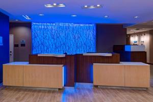 a lobby with a large blue screen in the background at Fairfield Inn & Suites by Marriott Atlanta Peachtree City in Peachtree City