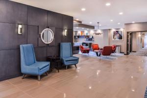 a lobby with chairs and a waiting room at Fairfield Inn & Suites by Marriott Raleigh Cary in Cary
