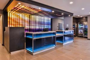 a lobby with blue counters and a wall of glass at Fairfield Inn & Suites by Marriott Raleigh Cary in Cary