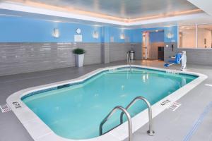 a large swimming pool in a hotel room at Fairfield Inn & Suites by Marriott Raleigh Cary in Cary