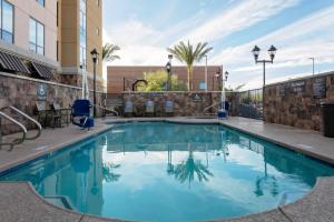 a swimming pool with blue water in a building at Residence Inn by Marriott Phoenix Mesa East in Ciela Grande Mobile Home Park