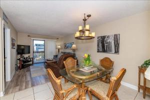 a living room with a dining room table and chairs at Unit 3306 - Ocean & Racquet Resort in Saint Augustine Beach