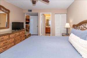 a bedroom with a large bed and a television at Unit 3306 - Ocean & Racquet Resort in Saint Augustine Beach