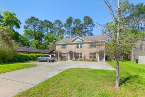 a house with a car parked in the driveway at Beautiful 3-suite home w/ patio dining, big yard in Tallahassee