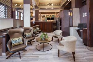 a waiting area with chairs and a table in a lobby at Courtyard by Marriott Cape Girardeau Downtown in Cape Girardeau