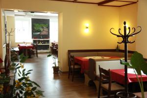 a restaurant with a table and chairs in a room at Pension Stadt Grein in Grein