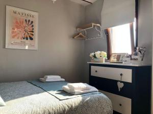 a small bedroom with a bed and a window at R2R - La LLastrina - 14A03 in Lastres