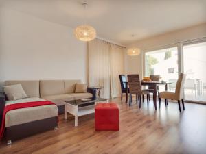 a living room with a couch and a table at Apartment Katja in Rogoznica