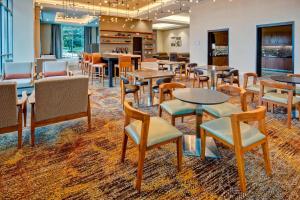 a restaurant with tables and chairs in a room at Residence Inn by Marriott Kansas City Downtown/Convention Center in Kansas City