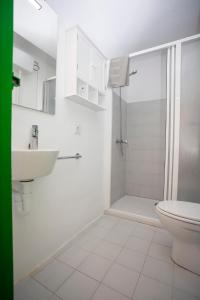 a white bathroom with a sink and a toilet at Sa Rapita see view - Grupo Berna in Sa Ràpita