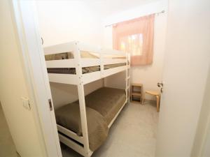 a bedroom with two bunk beds in a room at Apartment Marcello-5 by Interhome in Rosolina Mare