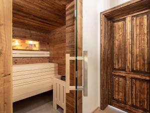 a sauna with wooden walls and a wooden door at Holiday Home Schnee Eule-6 by Interhome in Pfarrwerfen