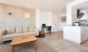 a living room with a couch and a table at Apartamento Torre Bona - Seafront, 10 meters from the beach! in Son Servera