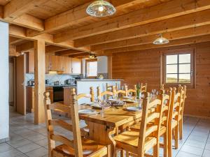 a dining room with a wooden table and chairs at Chalet Naulaz by Interhome in Val-d'Illiez