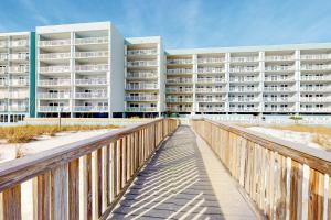 a large apartment building on the beach with a boardwalk at Islander E 2007 in Fort Walton Beach