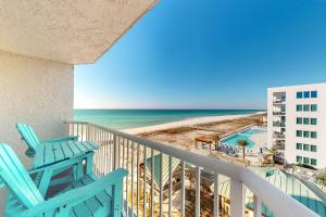 a balcony with two blue chairs and the beach at Islander W 605 in Fort Walton Beach