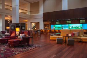 a hotel lobby with couches and a bar at Kansas City Marriott Downtown in Kansas City