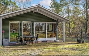 een klein groen huis met een tafel en stoelen bij Beautiful Home In Herning With Kitchen in Herning