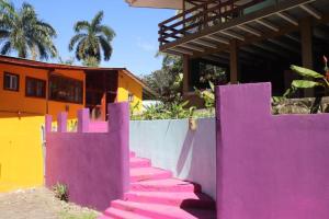 a set of pink stairs in front of a house at Planet B Hostel - Adults Only in Manuel Antonio