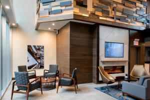 a lobby with chairs and a fireplace at TownePlace Suites by Marriott New York Long Island City in Queens